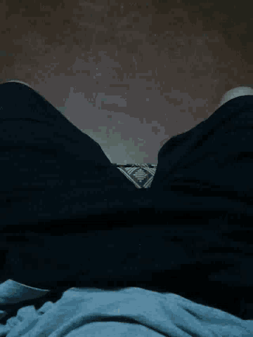 a black shirt with a triangle on the bottom of it