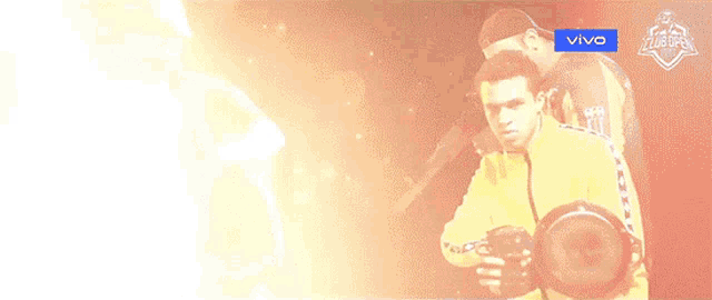 a man in a yellow jacket with the word vivo on the bottom