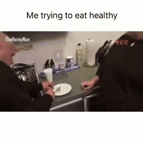 a man is sitting at a kitchen counter with a plate of food on it .