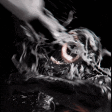 a close up of a monster 's face with a black background .