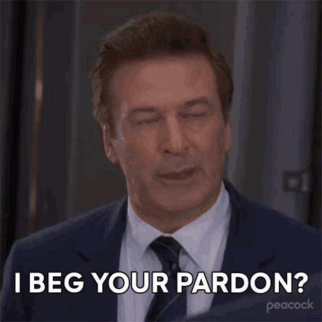 a man in a suit and tie is asking for pardon