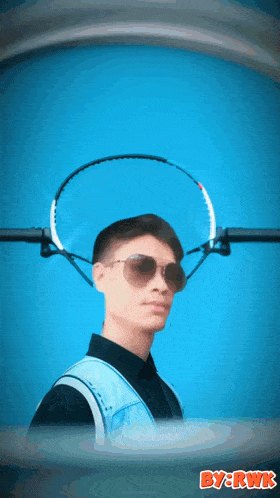 a man wearing sunglasses and a tennis racquet on his head