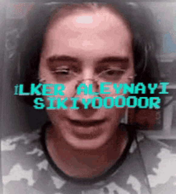 a close up of a person 's face with the words " ilker aleynavi sikiyodoor " written above it