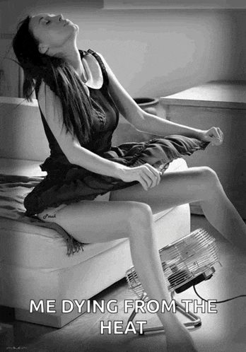 a black and white photo of a woman sitting on a couch with the caption me dying from the heat