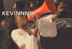 a woman is holding a megaphone in front of her face and shouting into it .