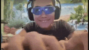 a girl wearing headphones and swimming goggles is giving a fist bump