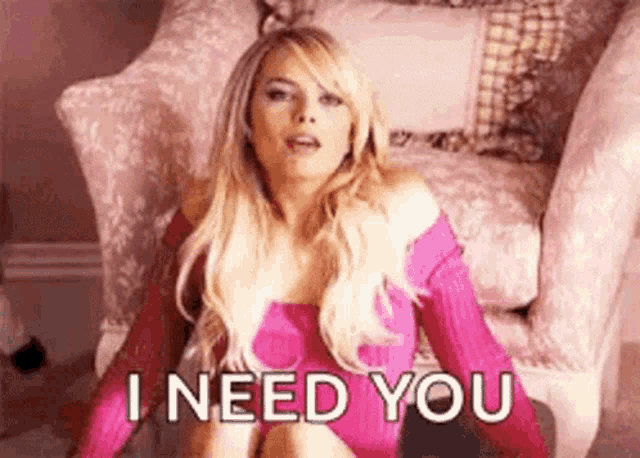 a woman is sitting in a chair with the words `` i need you '' written on her face .