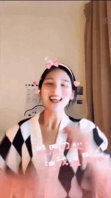 a woman is wearing a headband with hearts on it