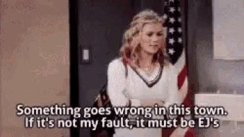 a woman is standing in front of an american flag and talking about something that goes wrong in this town .