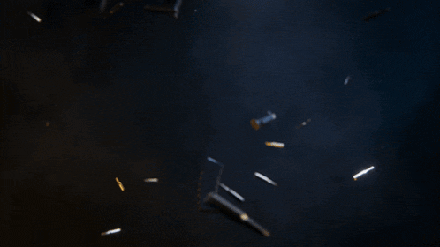 a blurred image of a rifle with bullets flying around it