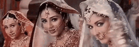 three brides are standing next to each other in a row and smiling .