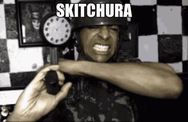 a man wearing a helmet is holding a gun in front of a clock that says skitchura on it .