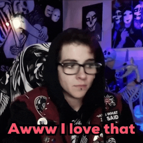 a young man wearing glasses and a hoodie says " awww i love that "