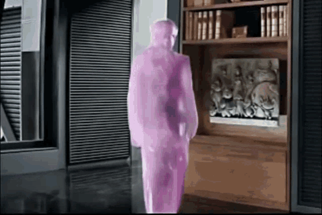 a purple statue of a man is walking in a room .