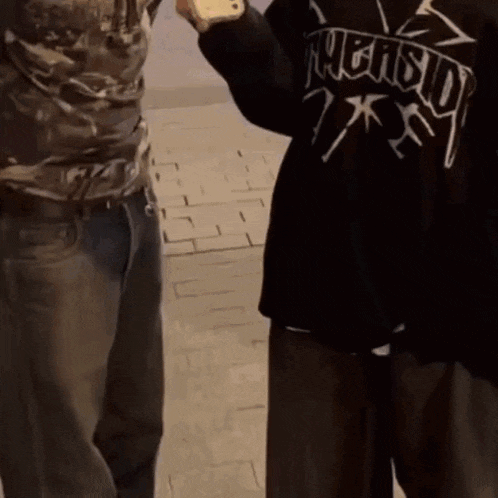 a person wearing a black shirt that says " friendship "