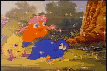 a group of cartoon birds are standing next to each other in a field .