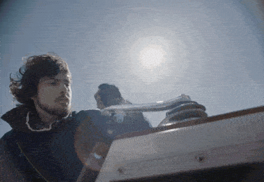 a man with a beard is working on a boat