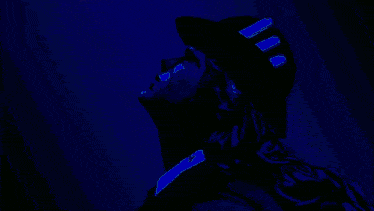 a cartoon character with blonde hair and a black hat with purple ribbons