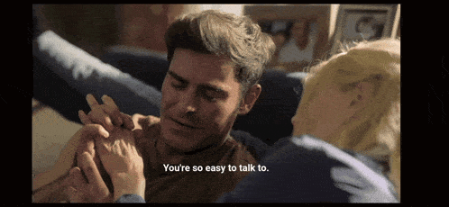 a man laying on a couch with a woman holding his hand and the words " you 're so easy to talk to "