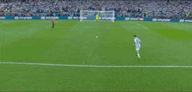 a soccer player wearing a number 12 jersey kicks the ball into the goal