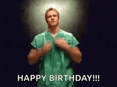 a man in a green scrub is dancing and saying `` happy birthday '' .