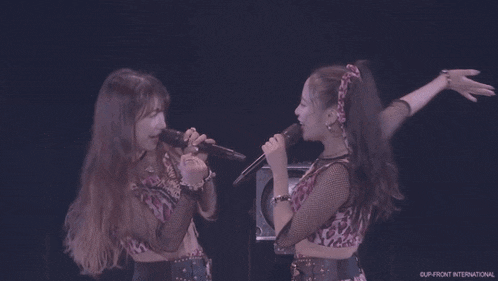 a group of young women are dancing on a stage .