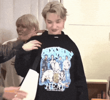 a man wearing a black sweatshirt that says beat