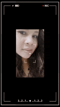 a woman 's face is being recorded with the numbers 3 2 1 and 2 visible