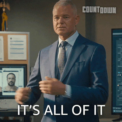 a man in a suit says it 's all of it in front of a computer