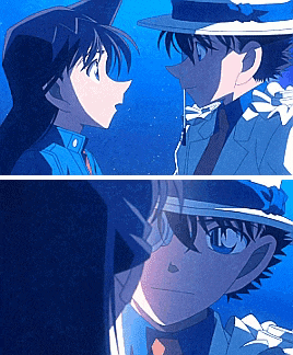a man and a woman are looking at each other and the man is wearing a hat