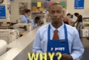 a man wearing an apron that says ' why ? ' on it