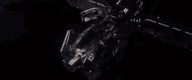 a space ship is flying over the earth in the night sky .