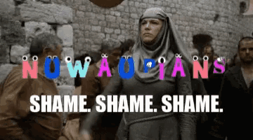 a woman stands in front of a crowd with the words nowaolfans shame shame shame written above her