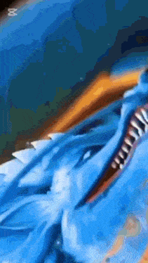 a close up of a blue dragon 's mouth with teeth