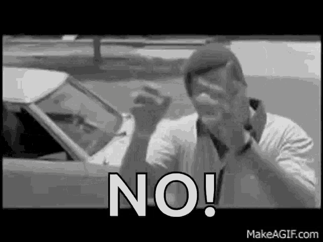 a man is sitting in a car making a funny face and saying `` no '' .
