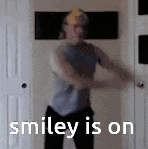 a blurry picture of a man dancing with the words smiley is on behind him