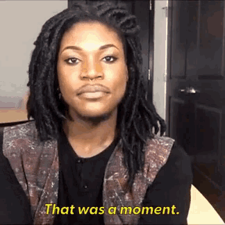 a man with dreadlocks says that was a moment in yellow letters