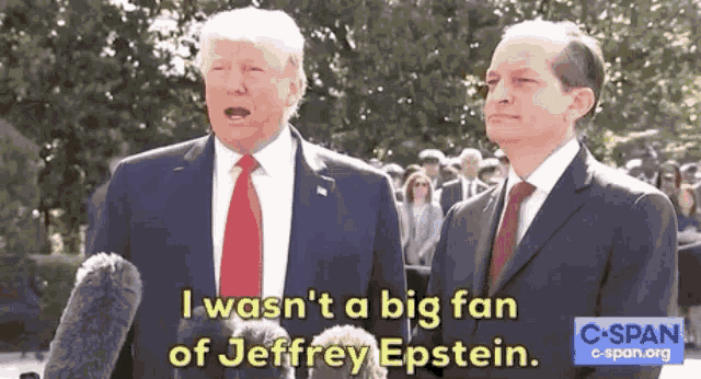 two men in suits and ties are standing next to each other and one of them says i wasn 't a big fan