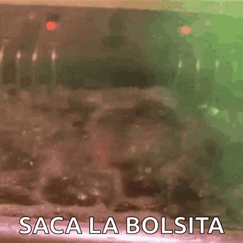 a bald man with a beard is in a bathtub with the words saca la bolsita written on it .
