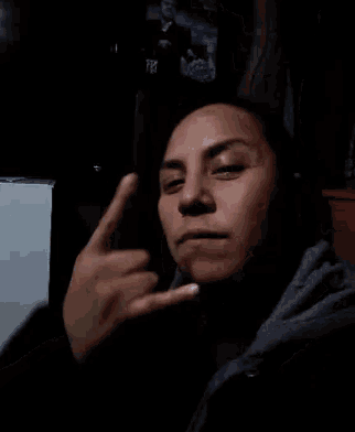 a close up of a person 's face with their fingers on their face