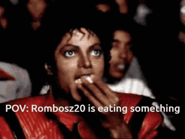 a man in a red jacket is eating something with the words " rombosz20 is eating something " below him