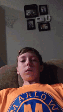 a young man wearing an orange shirt with the word marlow on it