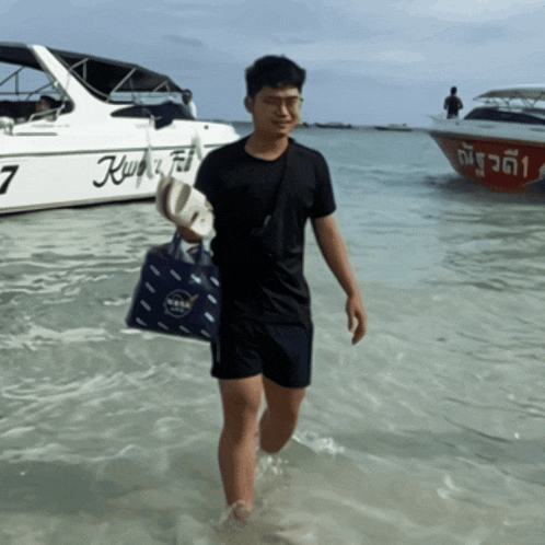 a man walking in the water near a boat with the number 7