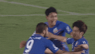 a soccer player with the number 15 on his back is laying on the ground