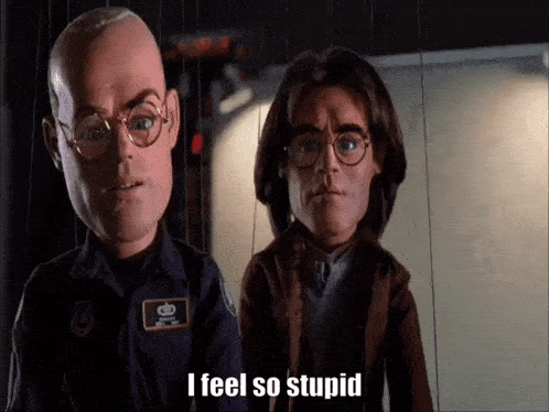 a man and a woman are standing next to each other and one of them is talking .