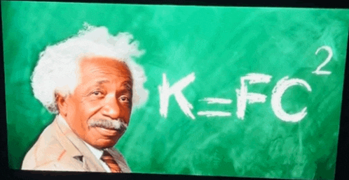 a man stands in front of a green chalkboard with k = fc written in white chalk