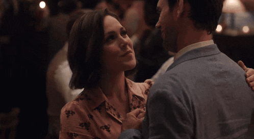 a man and a woman are looking at each other