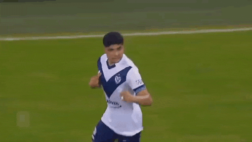 two soccer players are running on the field during a game .