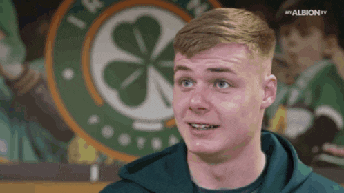 a man stands in front of a celtic logo and says my albion tv