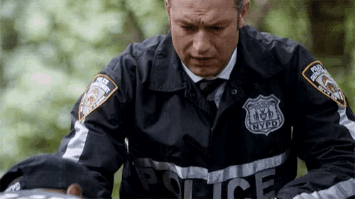 a man in a black jacket with nypd written on it